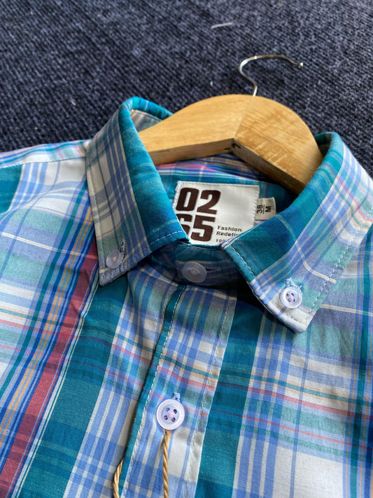 A premium yarn-dyed paper cotton full-sleeve shirt by 0265 featuring a button-down collar, tailored fit, and back-side center box pleat. Designed in vibrant summer shades with a timeless check pattern, offering breathability, comfort, and versatility for casual and semi-formal wear. Perfectly pairs with jeans, chinos, or shorts for a stylish seasonal look.